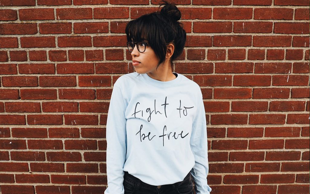 A girl wearing the the classic long sleeve t-shirt, which is the third most popular t-shirt style.