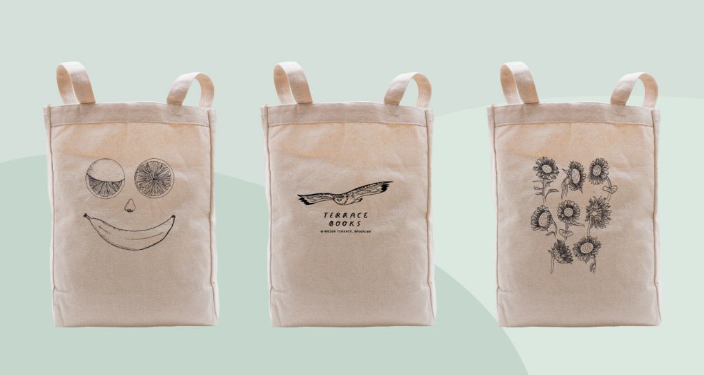 Natural color tote bags that use black ink on their design.