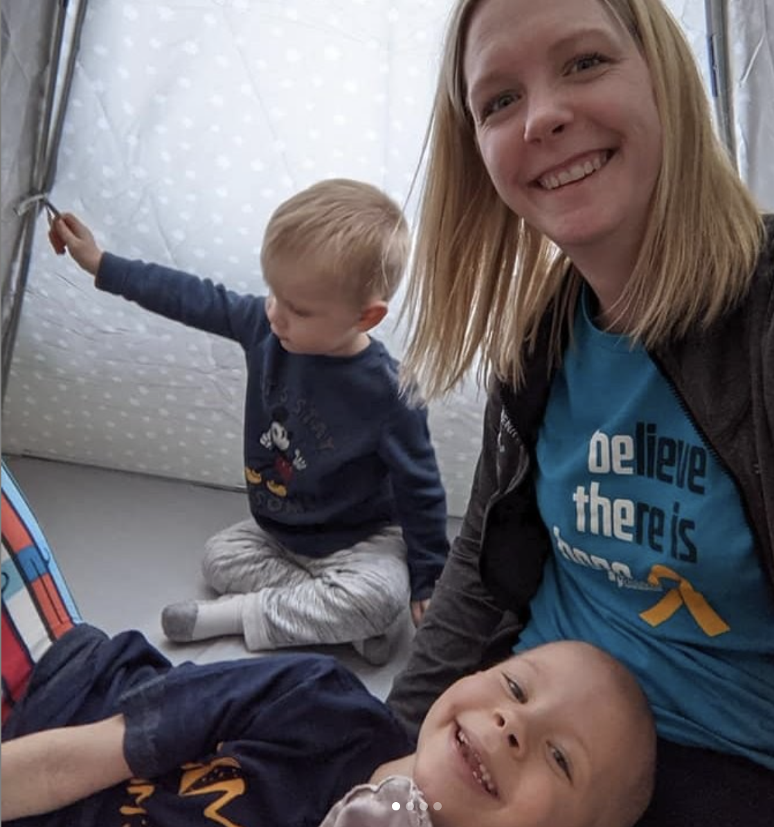 A mother and children wearing ACCO Cancer Awareness Month shirts.