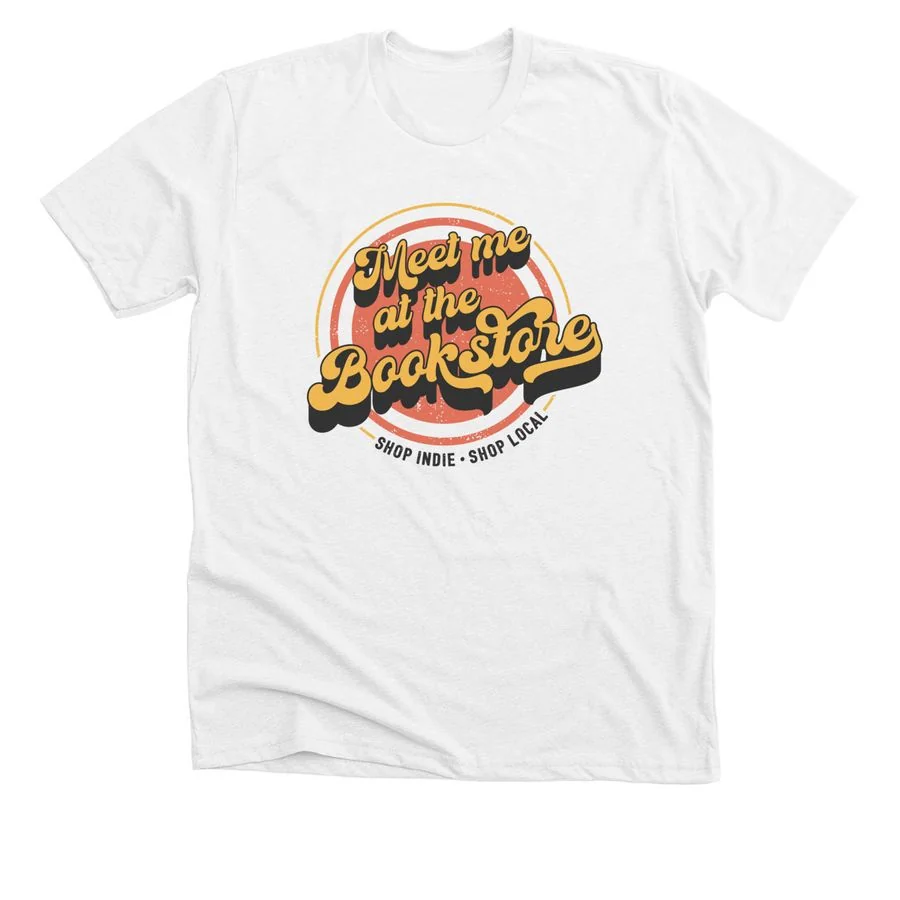 Solid white blend t-shirt featuring 'Meet Me At The Bookstore' design with colorful retro badge graphic