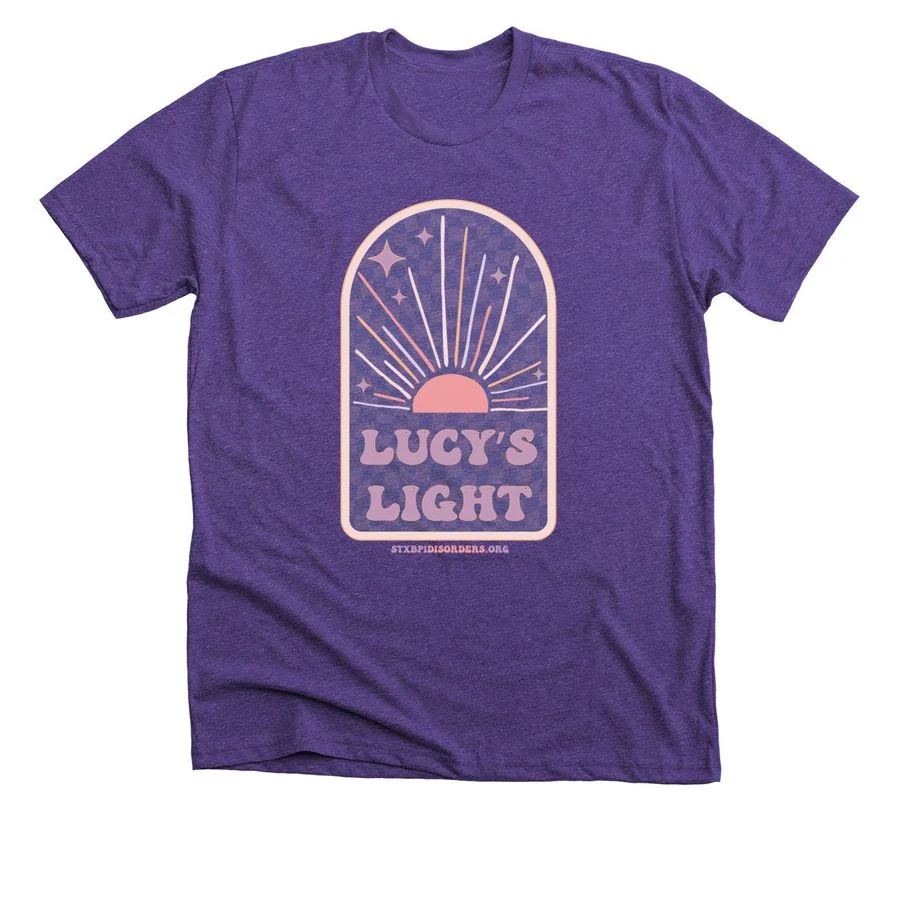 Heather team purple t-shirt featuring 'Lucy's Light' design with sunburst and pink badge graphic