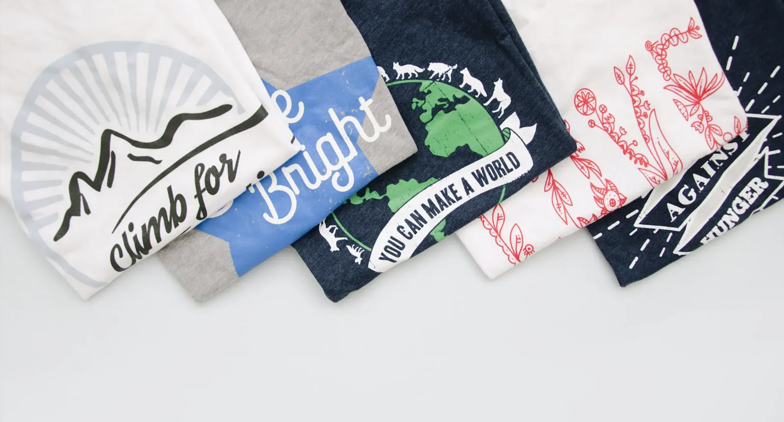 Collage of various colored t-shirts displaying different t-shirt designs, representing the 15 best t-shirt colors for 2026