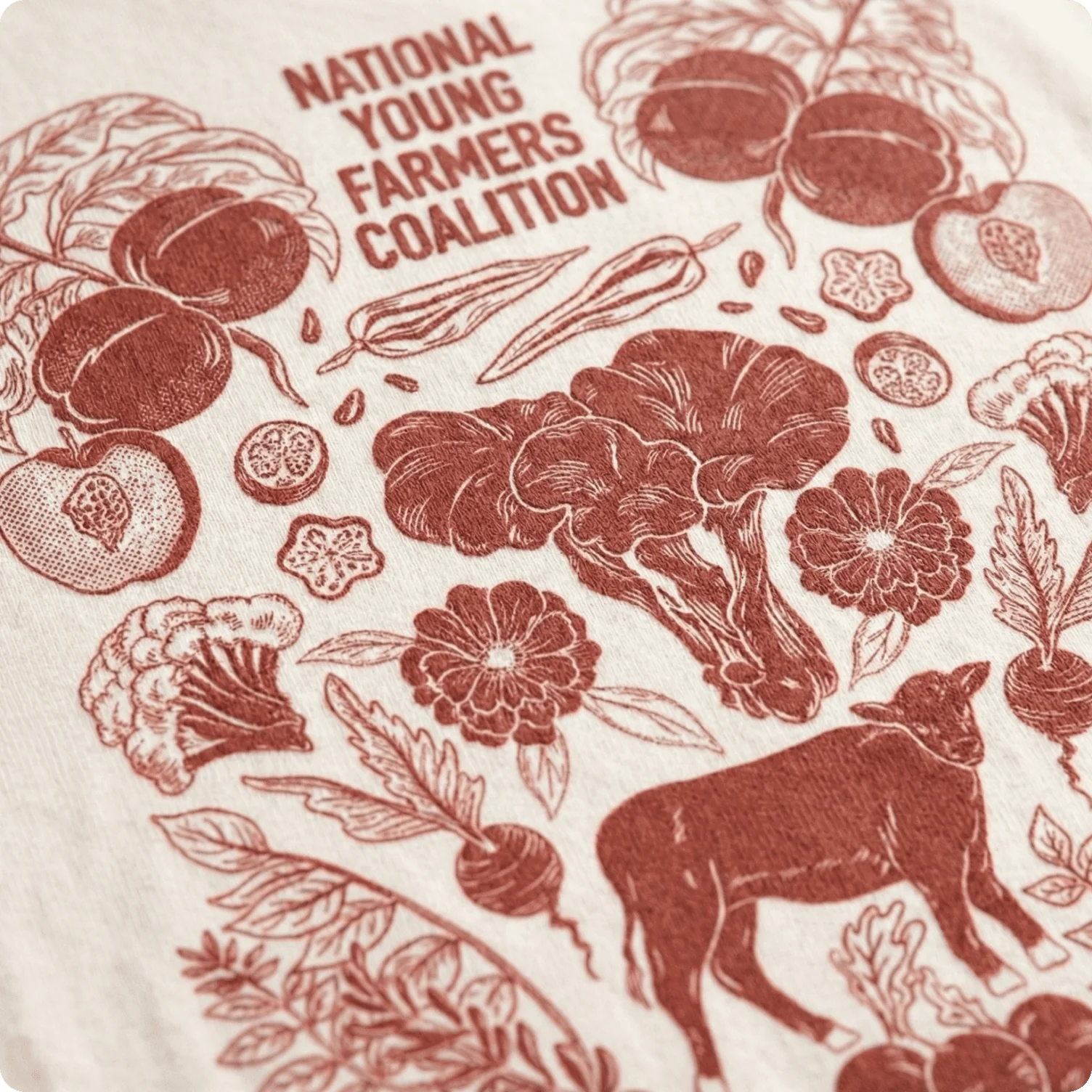 T-shirt featuring detailed farm-to-table illustration showcasing vegetables and livestock.