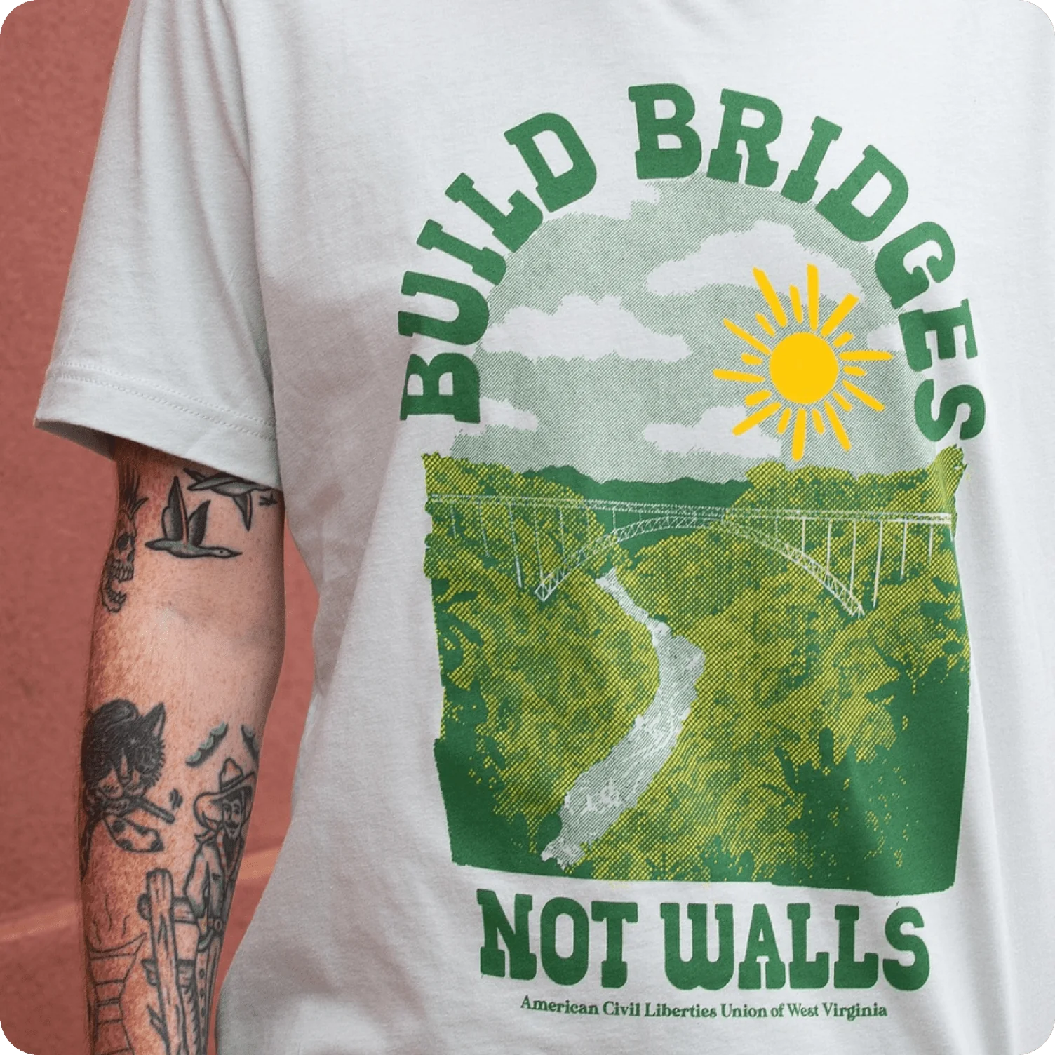 T-shirt featuring arched headline text with a scenic illustration inspired by vintage posters.